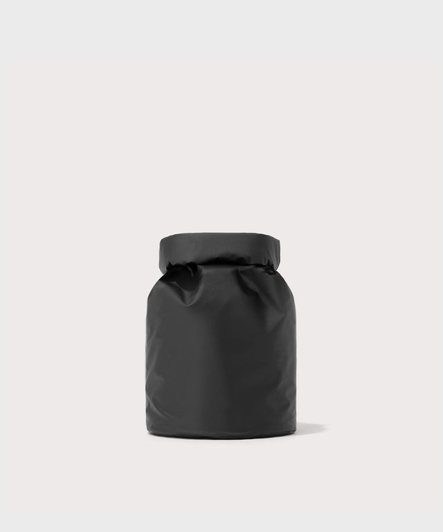 Dagne Dover Rae Roll-Top Dry Bag in black seen from the back.
