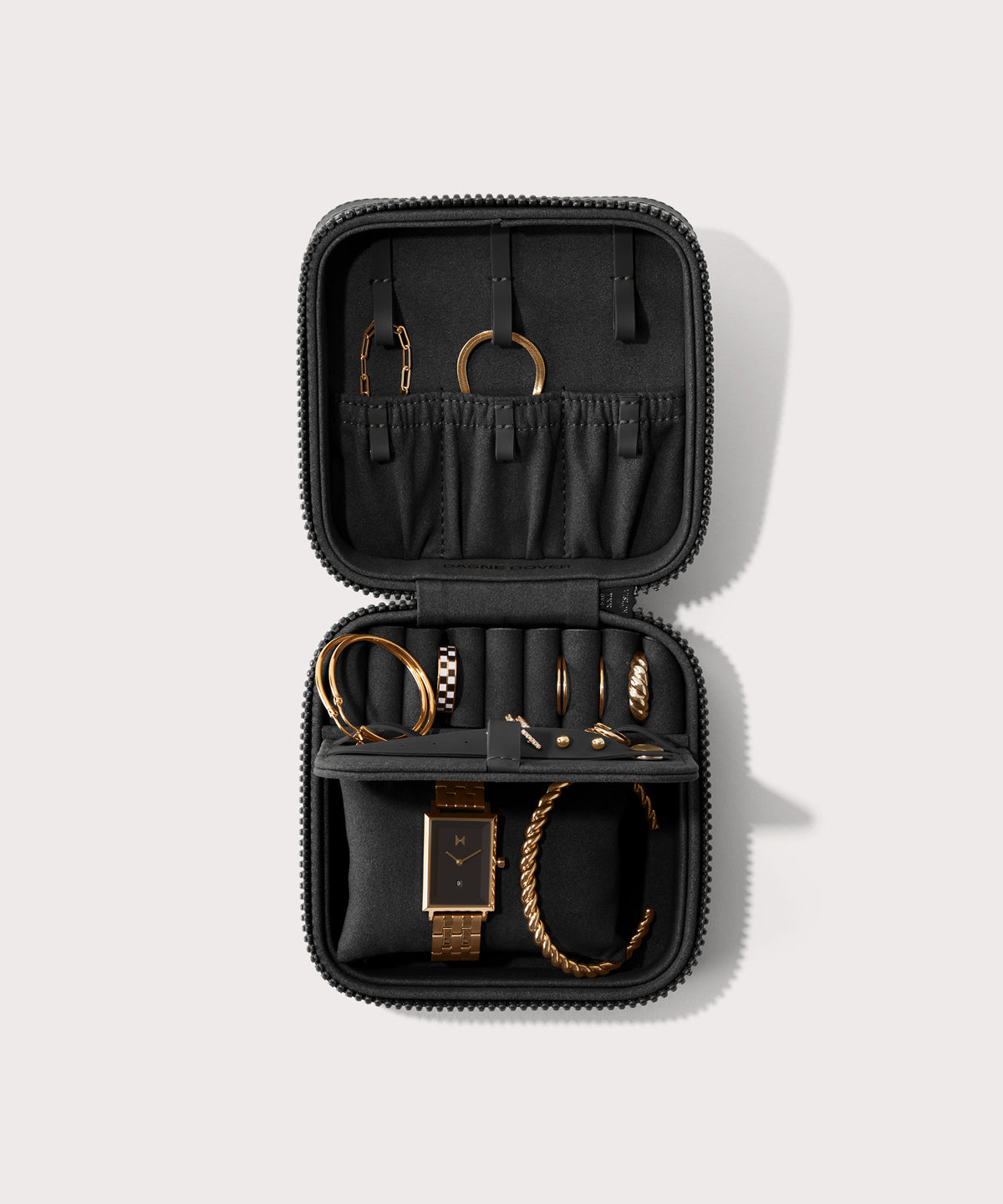 Dagne Dover Large Frankie Jewelry Case in black, seen open from above with jewelry inside the interior compartment.