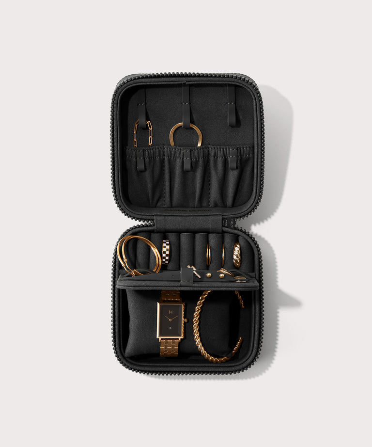 Dagne Dover Large Frankie Jewelry Case in black, seen open from above with jewelry inside the interior compartment.