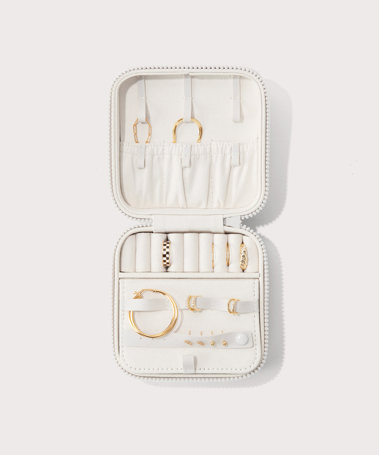 Dagne Dover Large Frankie Jewelry Case in white, seen open from above with jewelry inside the interior compartment.