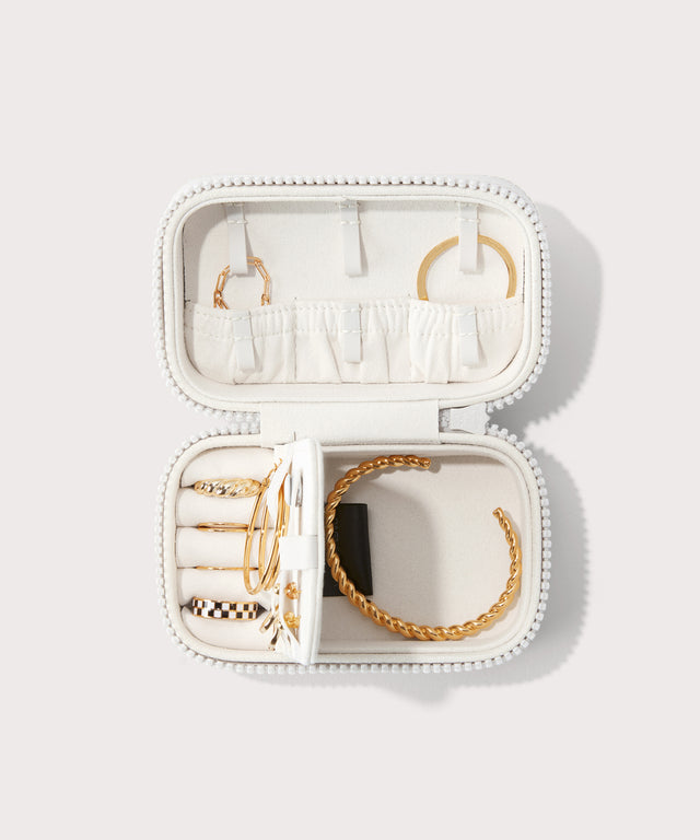 Dagne Dover small Frankie Jewelry Case in white, seen open from above with jewelry inside the interior compartment.