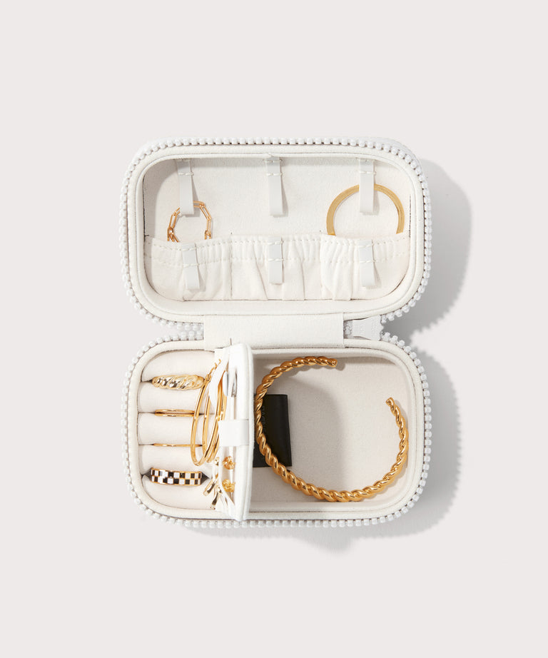 Dagne Dover small Frankie Jewelry Case in white, seen open from above with jewelry inside the interior compartment.