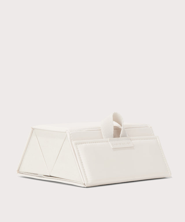 Dagne Dover Remi foldable glasses holder in white seen from an angle.
