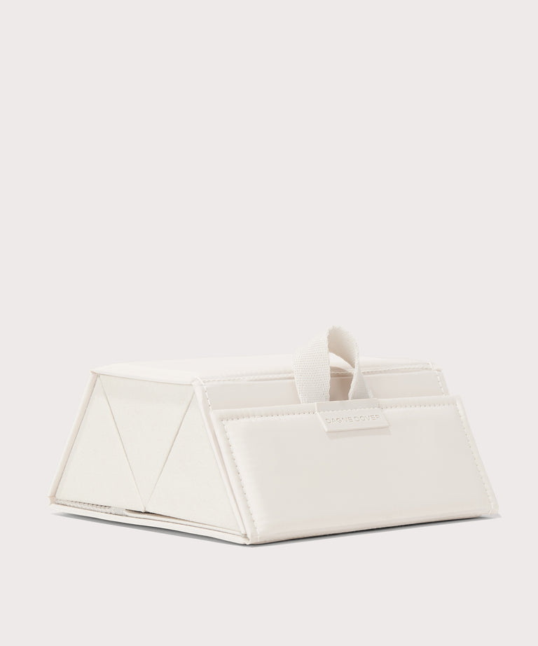 Dagne Dover Remi foldable glasses holder in white seen from an angle.
