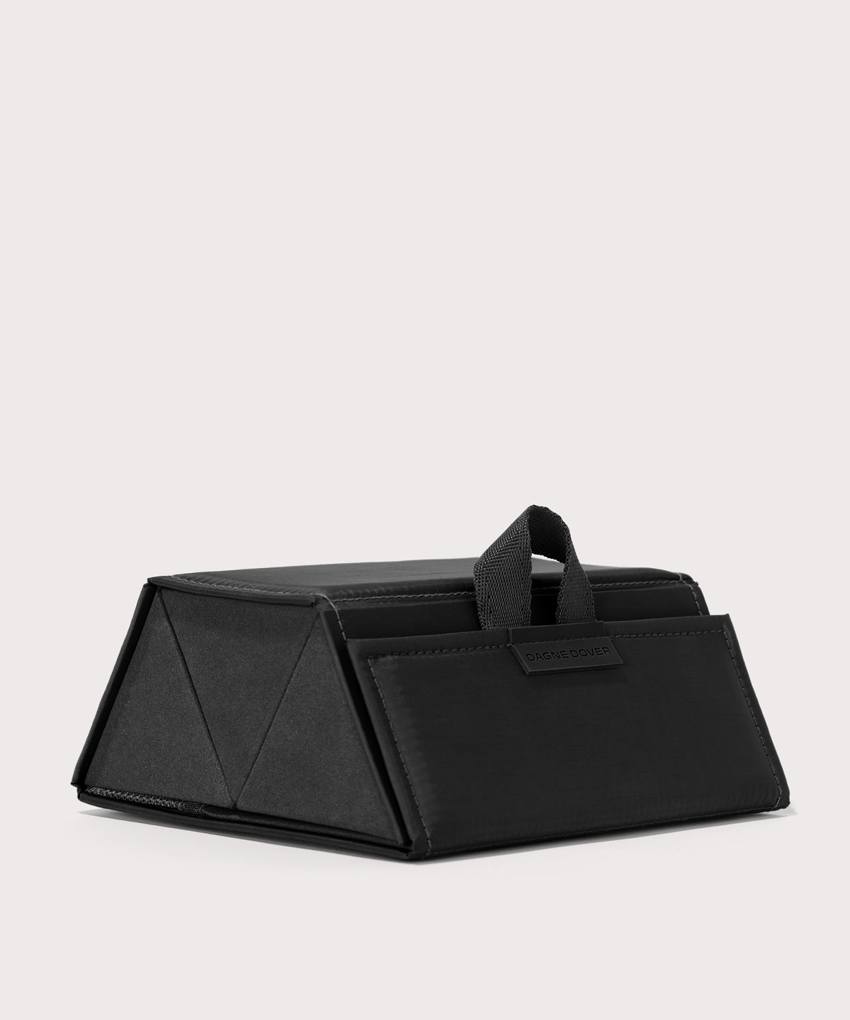 Dagne Dover Remi foldable glasses holder in black seen from an angle.
