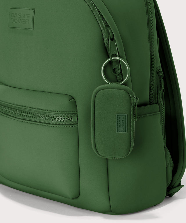 Dagne Dover Mara Keychain in a rich, classic forest green clipped onto a backpack. 