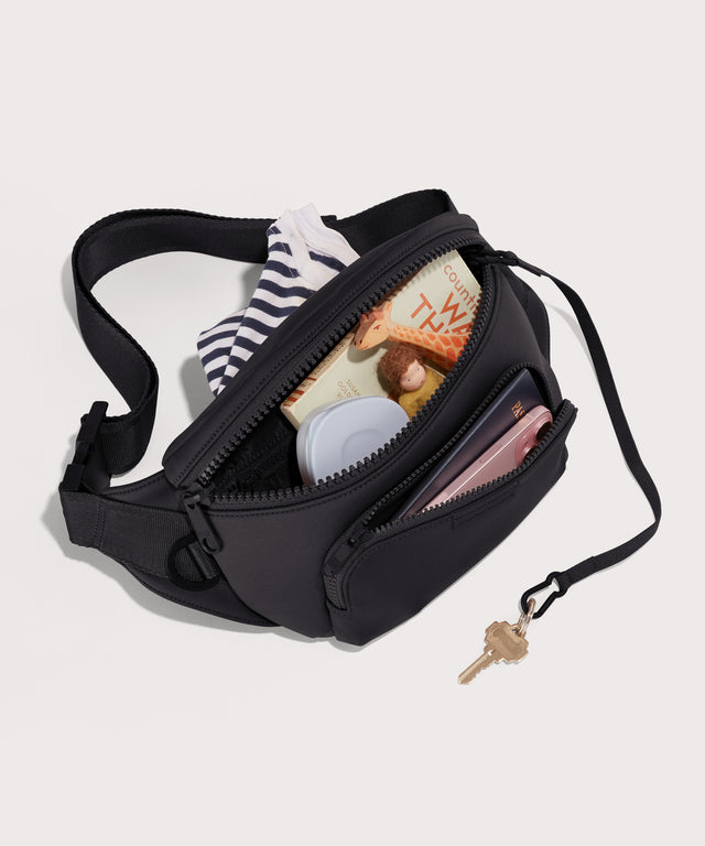 Dagne Dover jax large Fanny Pack in black unzipped, exposing the interior pockets.