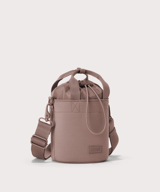 Dagne Dover Nico Bucket Bag in pink, side angle.
