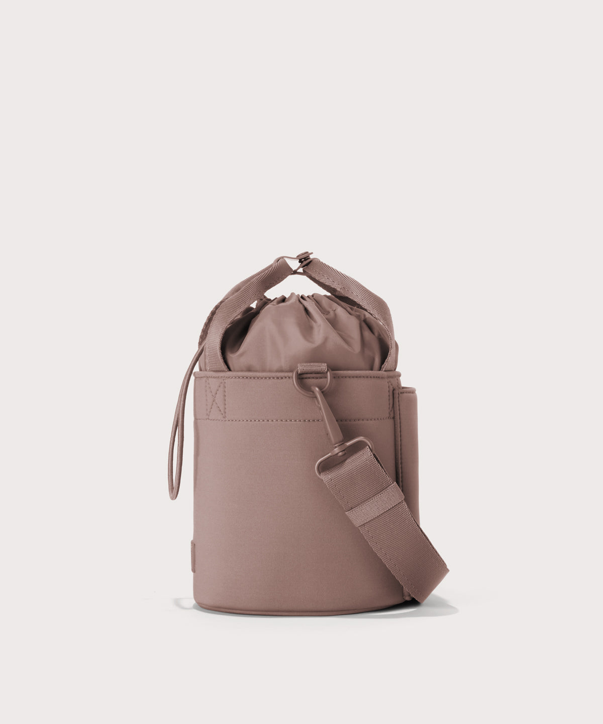 Dagne Dover Nico Bucket Bag in pink, side angle.
