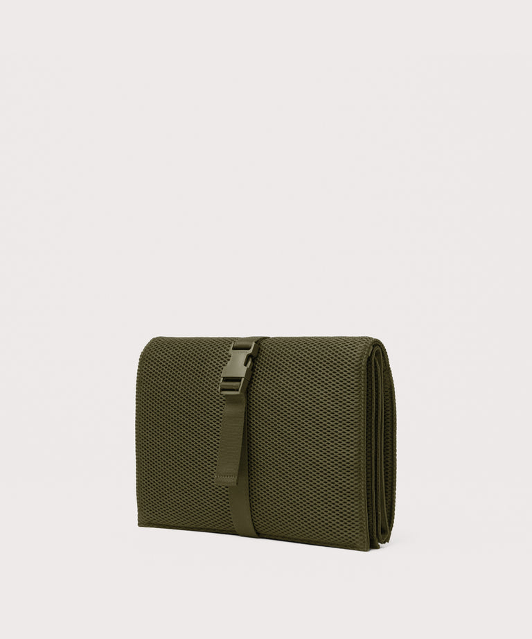 Dagne Dover Joey Changing Kit in dark moss seen from an angle.
