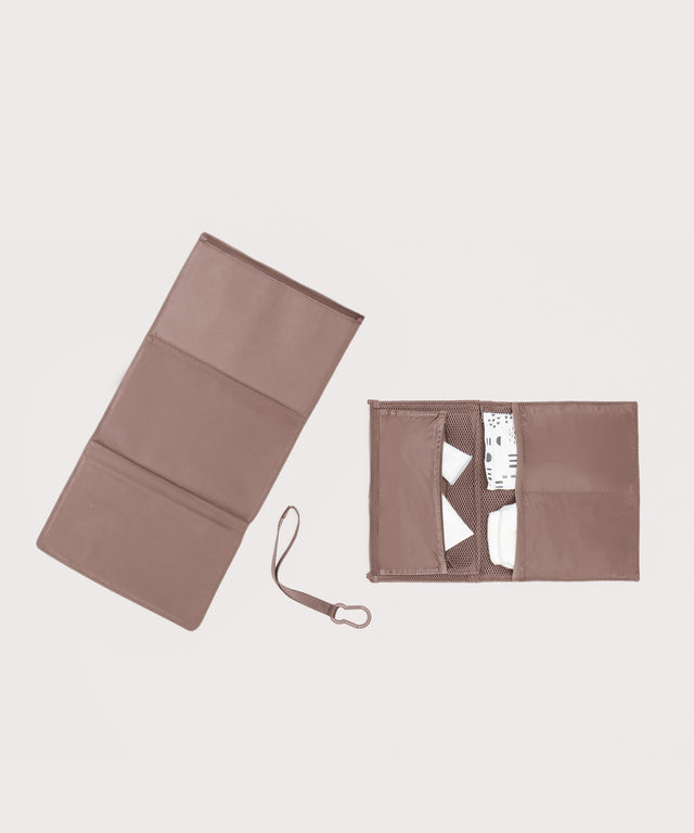 Dagne Dover Joey Changing Kit in pink unfolded, revealing the detachable changing mat.
