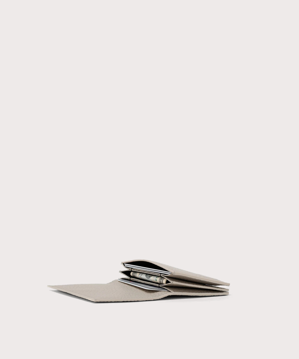 hover - Dagne Dover Accordion Card Case in white opened, revealing the three internal gusseted card slots.