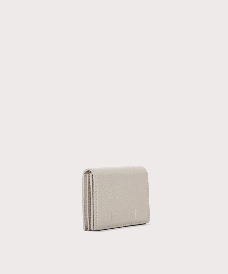 Dagne Dover Accordion Card Case in white seen from an angle.