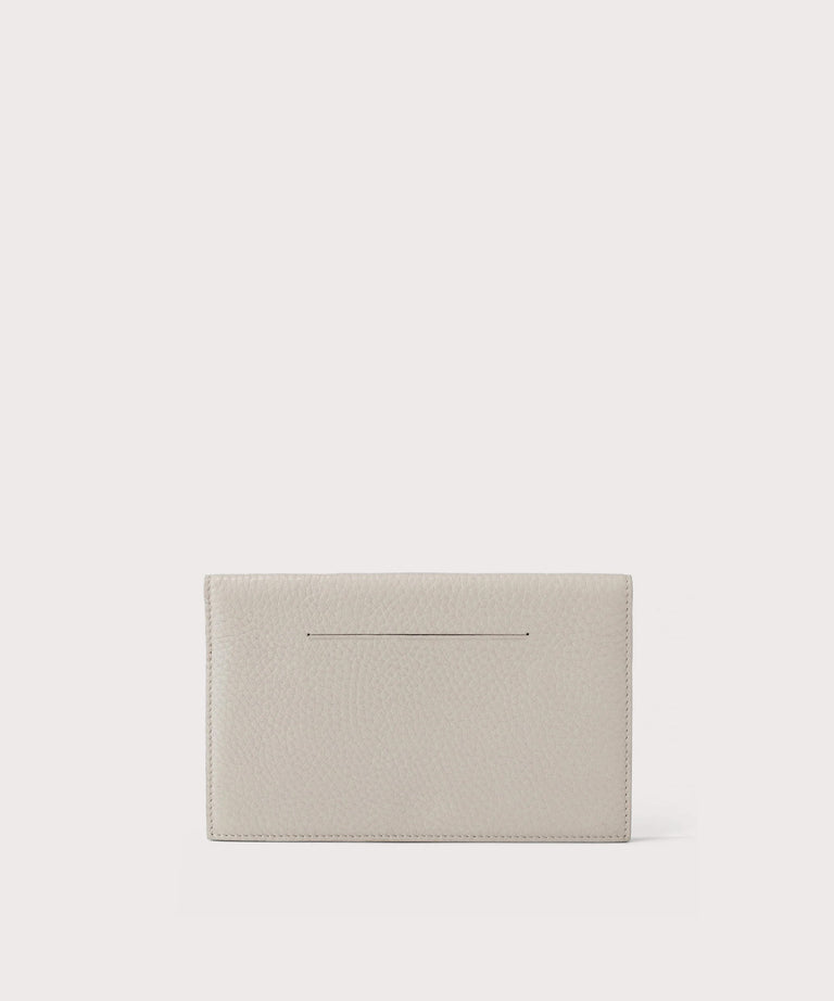 Dagne Dover Accordion Travel Wallet in white, revealing the external card slot.
