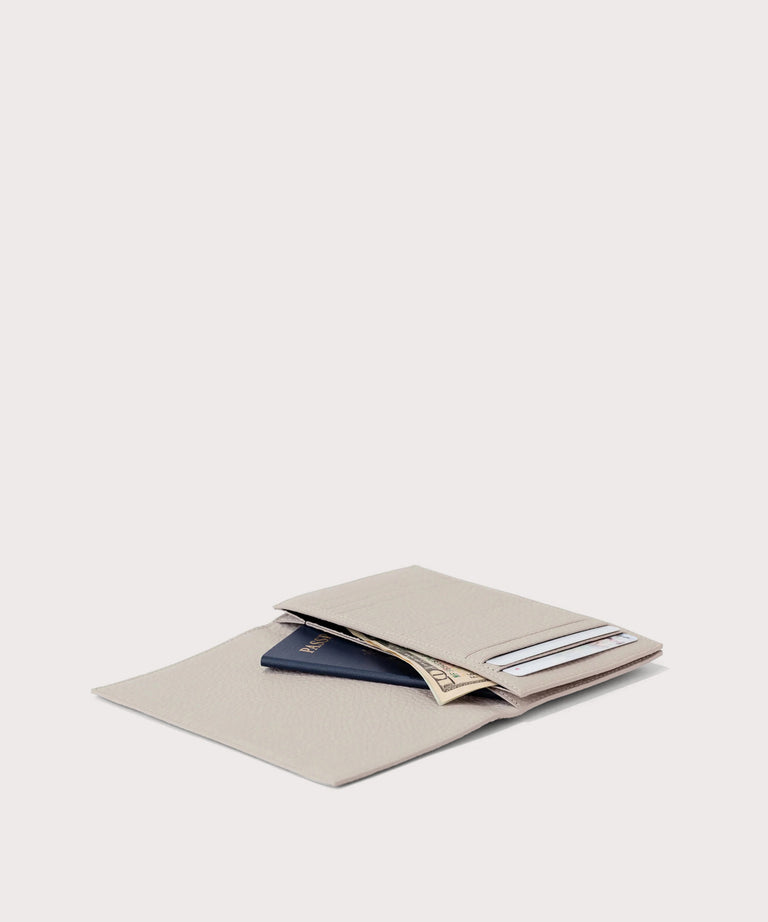 hover - Dagne Dover Accordion Travel Wallet in white opened, revealing the internal card slots and internal gusseted card and passport slots.