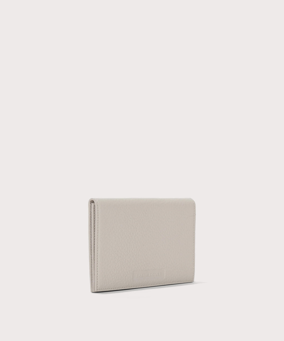 Dagne Dover Accordion Travel Wallet in white seen from an angle.
