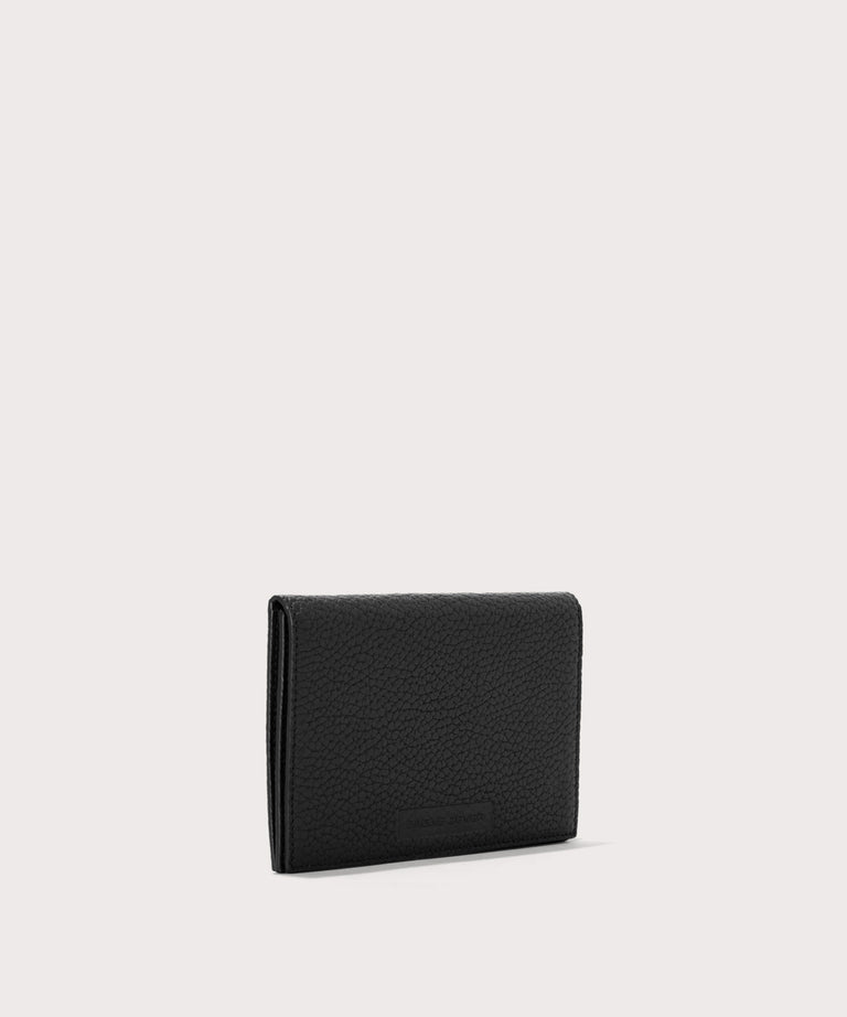 Dagne Dover Accordion Travel Wallet in black seen from an angle.
