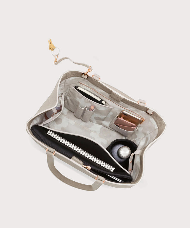 hover - Dagne Dover large Allyn Tote in grey with objects inside the interior pockets.
