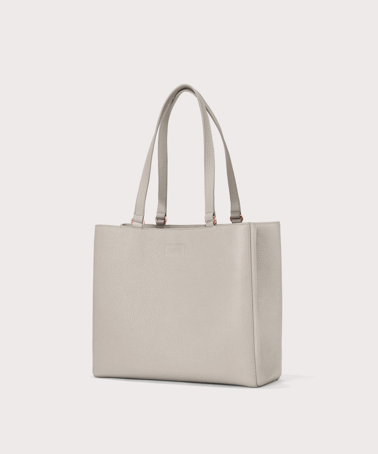 Dagne Dover medium Allyn Tote in light grey seen from an angle.
