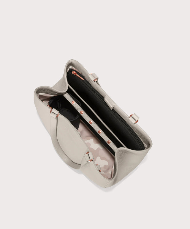 Dagne Dover medium Allyn Tote in light grey seen from above, revealing the interior slip pockets and laptop sleeve.
