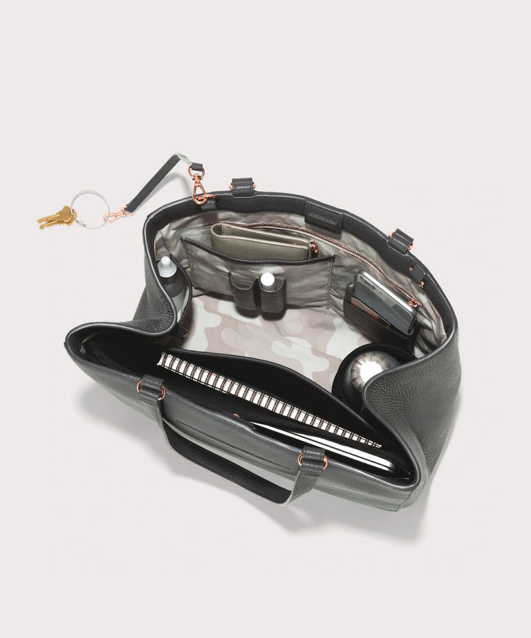 hover - Dagne Dover large Allyn Tote in grey with objects inside the interior pockets.
