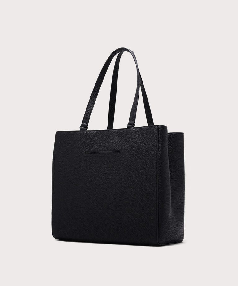 Dagne Dover large Allyn Tote in black with the exterior slip pocket.
