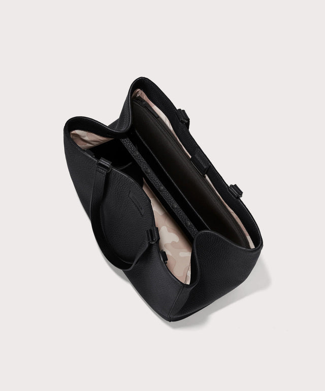 Dagne Dover large Allyn Tote in black seen from above, revealing the interior slip pockets and laptop sleeve.
