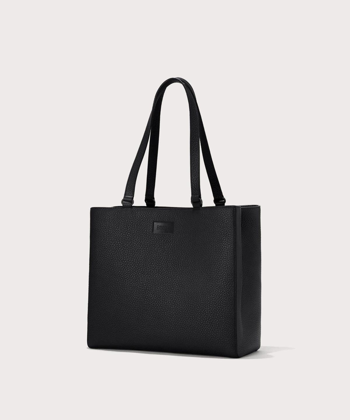 Dagne Dover medium Allyn Tote in black seen from an angle.
