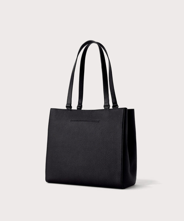 Dagne Dover medium Allyn Tote in black with the exterior slip pocket.
