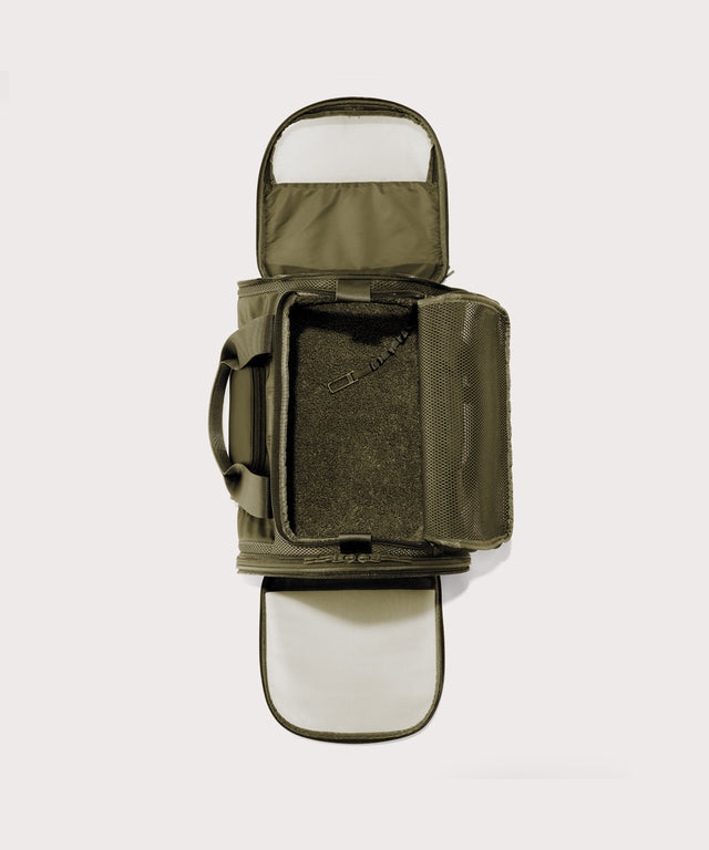 Dagne Dover Large Kyoto Pet Carrier in a deep olive green seen unzipped, top down view.
