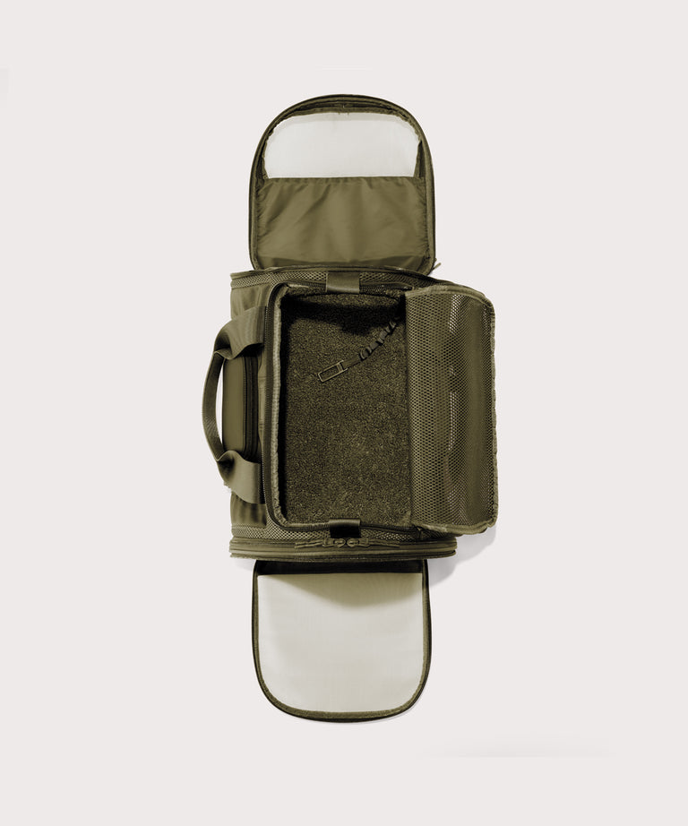 Dagne Dover Large Kyoto Pet Carrier in a deep olive green seen unzipped, top down view.
