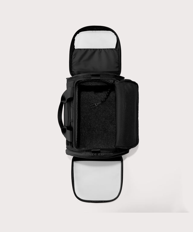 Dagne Dover Large Kyoto Pet Carrier in black seen unzipped, top down view.
