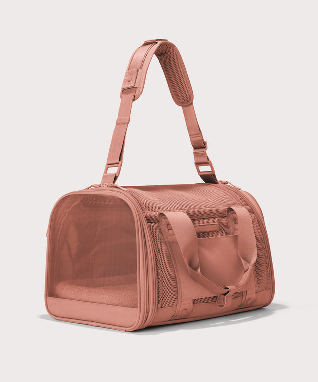 Dagne Dover Large Kyoto Pet Carrier in a warm dust pink seen from a back angle with crossbody strap.
