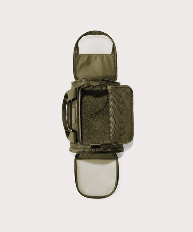 Dagne Dover small Kyoto Pet Carrier in a deep olive green seen unzipped, top down view.
