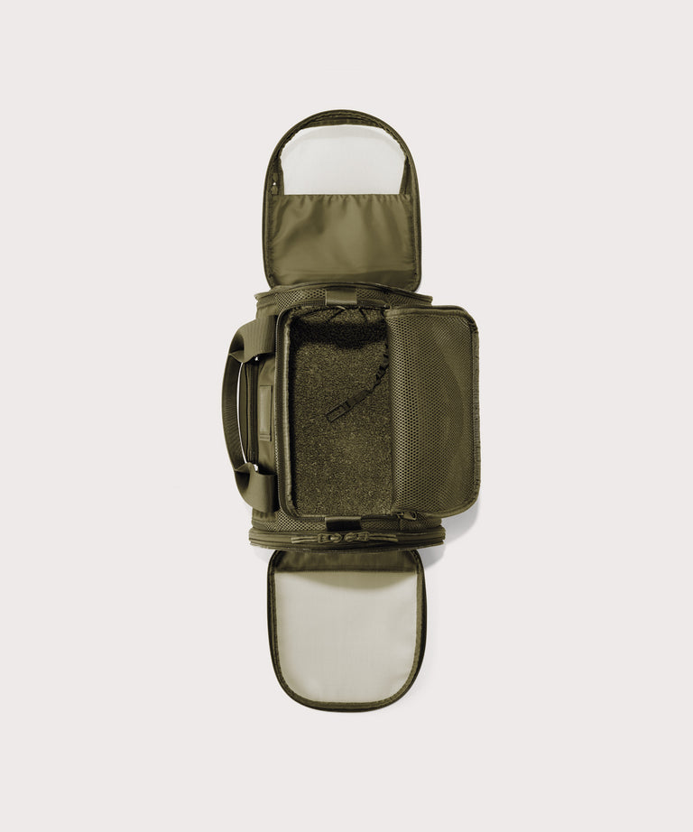 Dagne Dover small Kyoto Pet Carrier in a deep olive green seen unzipped, top down view.
