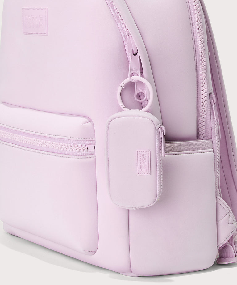 Dagne Dover Mara Keychain in a soft purple with grey undertones clipped onto a backpack. 
