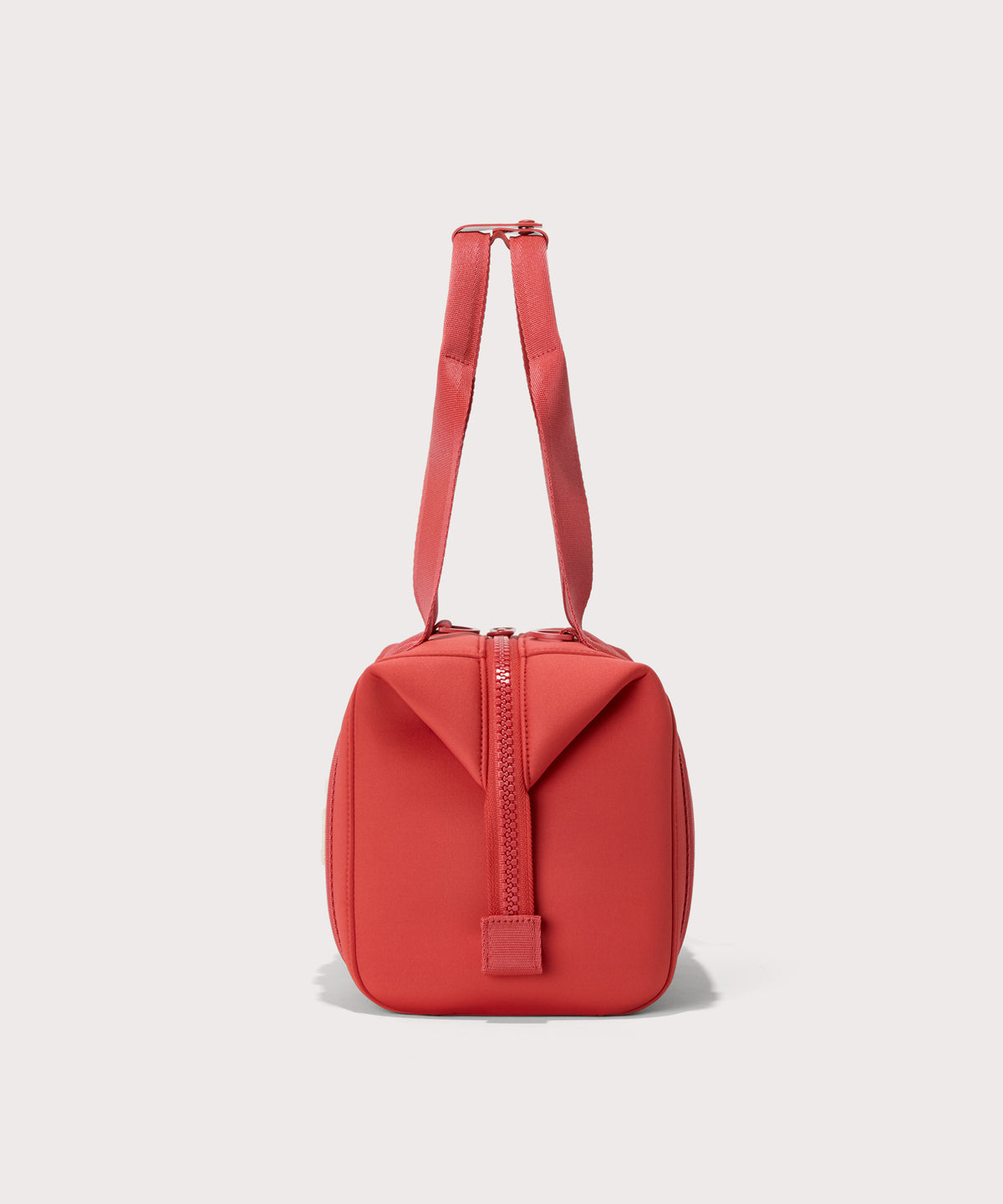 small Landon Carryall in a poppy, vintage wash red, side view
