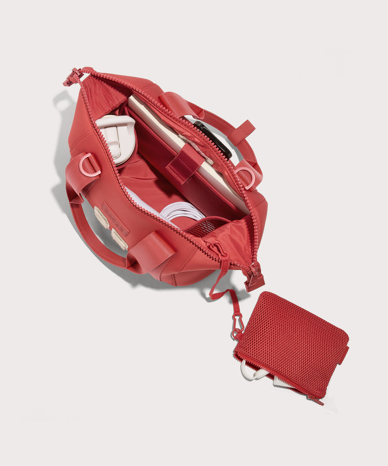 small Landon Carryall in a poppy, vintage wash red unzipped, top down view