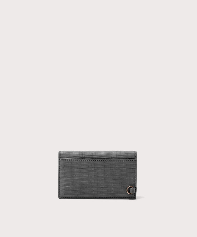 Dagne Dover vegan Card Case in grey seen from the back revealing the one external card slot.
