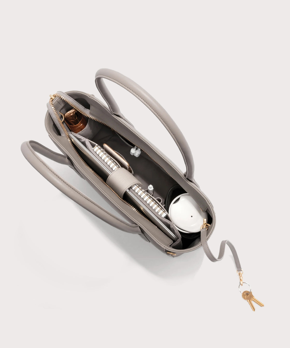 Dagne Dover classic Signature Leather Tote in beige seen from above, revealing 2 slip pockets, the neoprene bottle holder, and large interior zipper pocket.