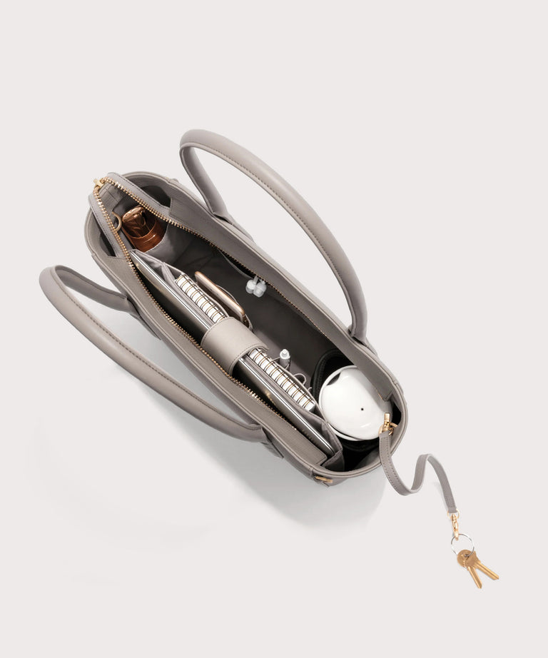 Dagne Dover classic Signature Leather Tote in beige seen from above, revealing 2 slip pockets, the neoprene bottle holder, and large interior zipper pocket.