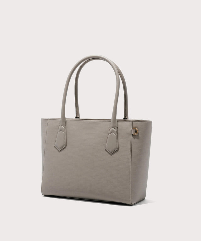 Dagne Dover classic Signature Leather Tote in beige seen from an angle.
