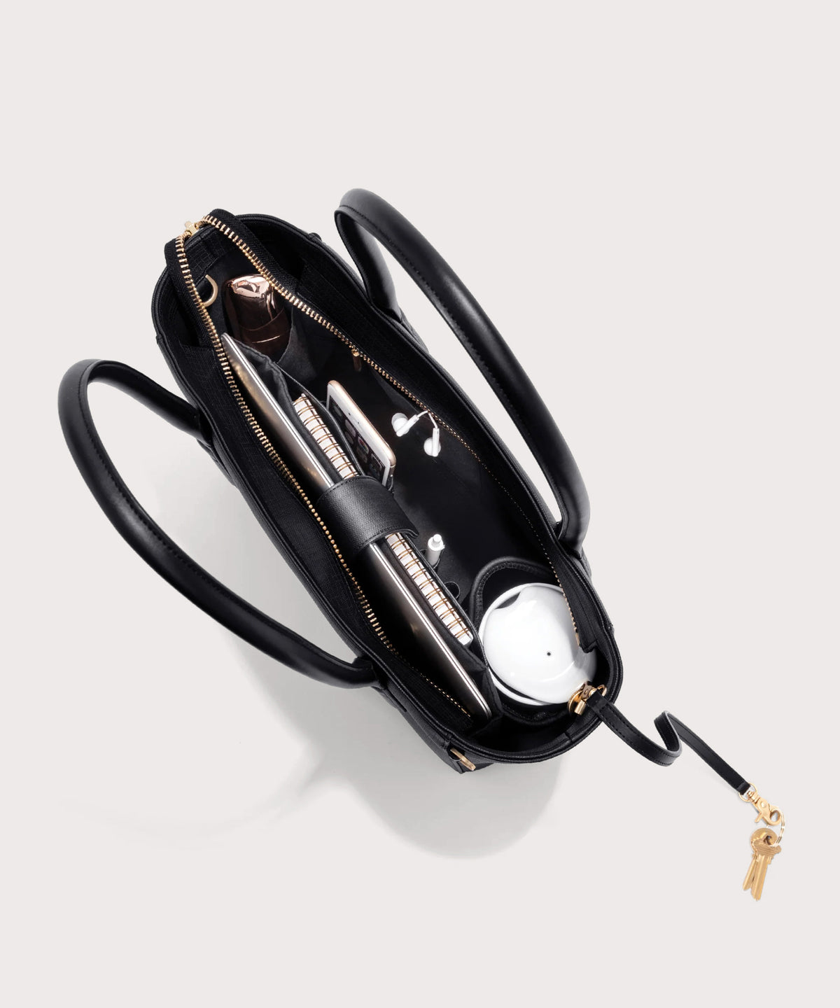 Dagne Dover classic Signature Leather Tote in black seen from above, revealing 2 slip pockets, the neoprene bottle holder, and large interior zipper pocket.