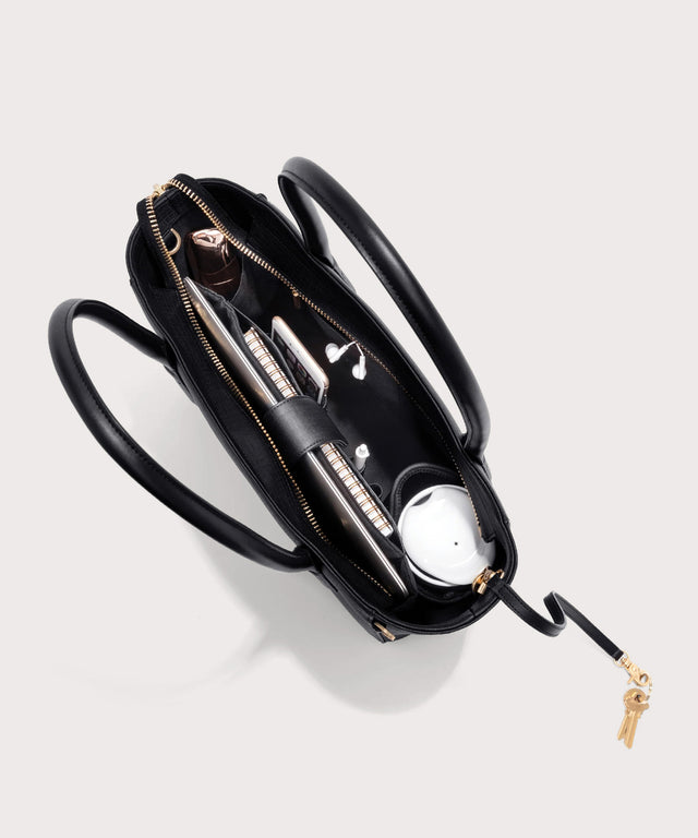 Dagne Dover classic Signature Leather Tote in black seen from above, revealing 2 slip pockets, the neoprene bottle holder, and large interior zipper pocket.