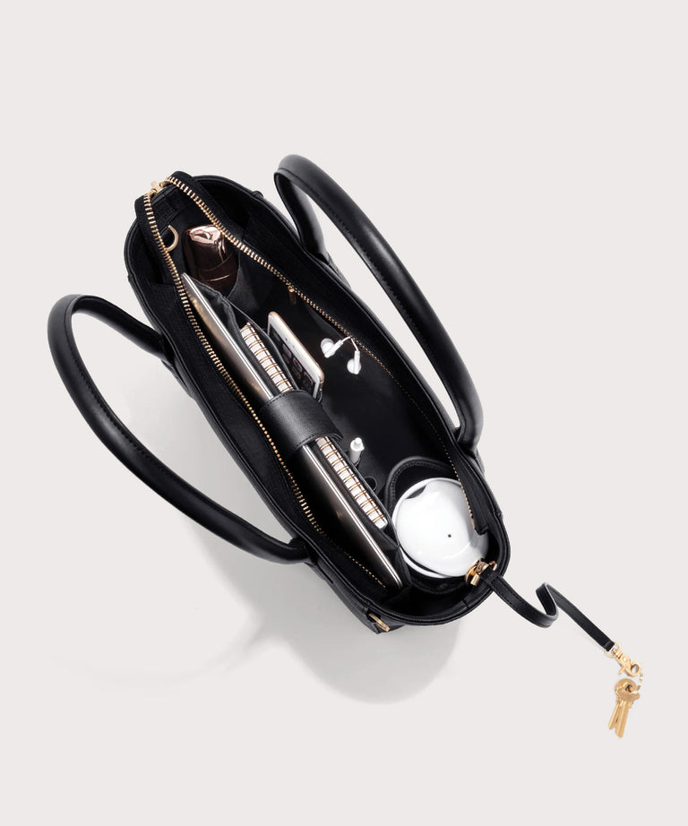 Dagne Dover classic Signature Leather Tote in black seen from above, revealing 2 slip pockets, the neoprene bottle holder, and large interior zipper pocket.