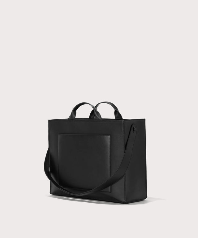 Dagne Dover medium vegan Daily Tote in black seen from an angle.
