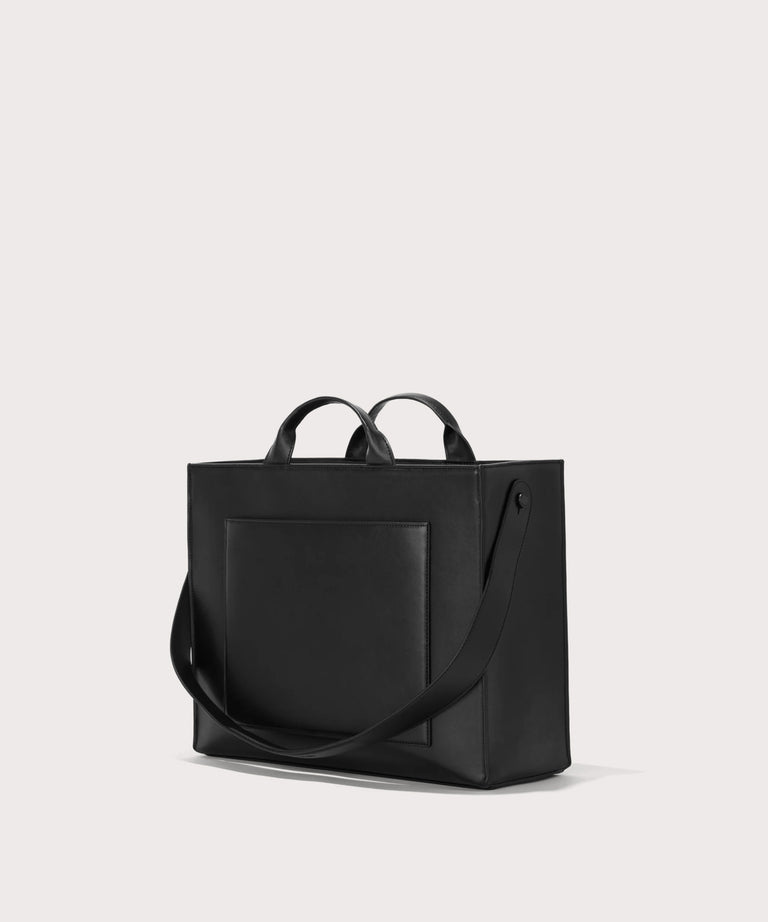 Dagne Dover medium vegan Daily Tote in black seen from an angle.
