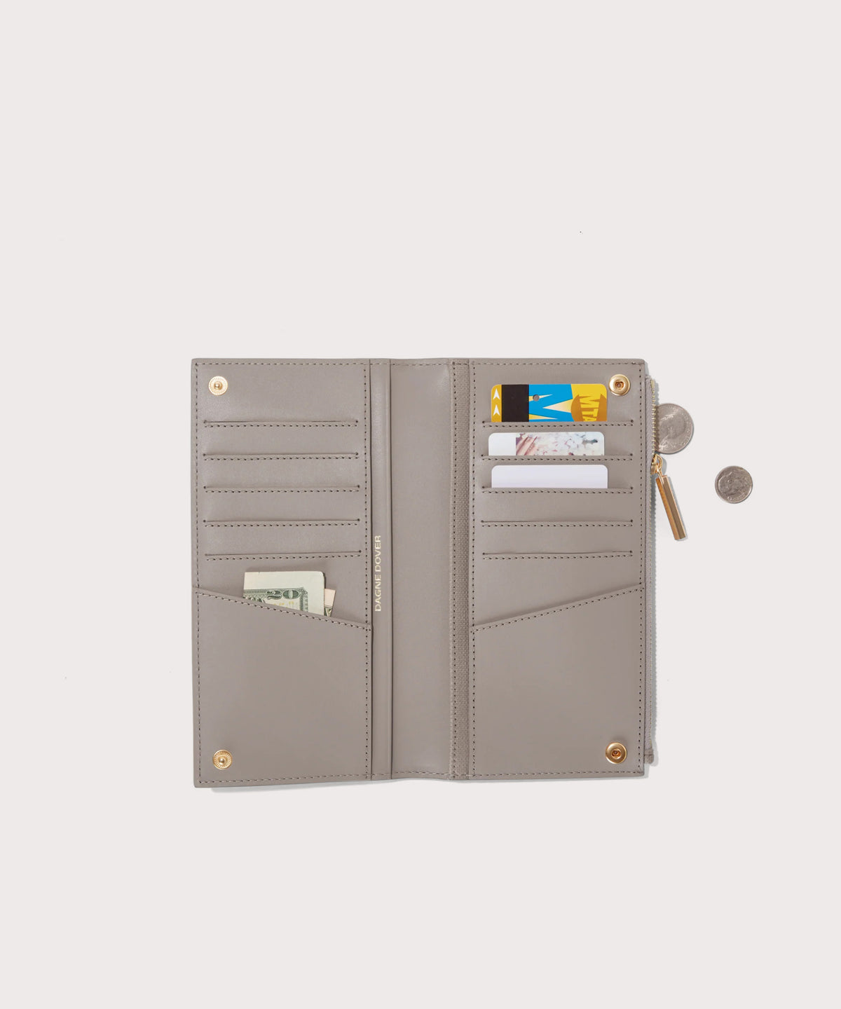 Dagne Dover Slim Wallet in beige unclasped, revealing ten card slots, two additional slip pockets, and four cash pockets.