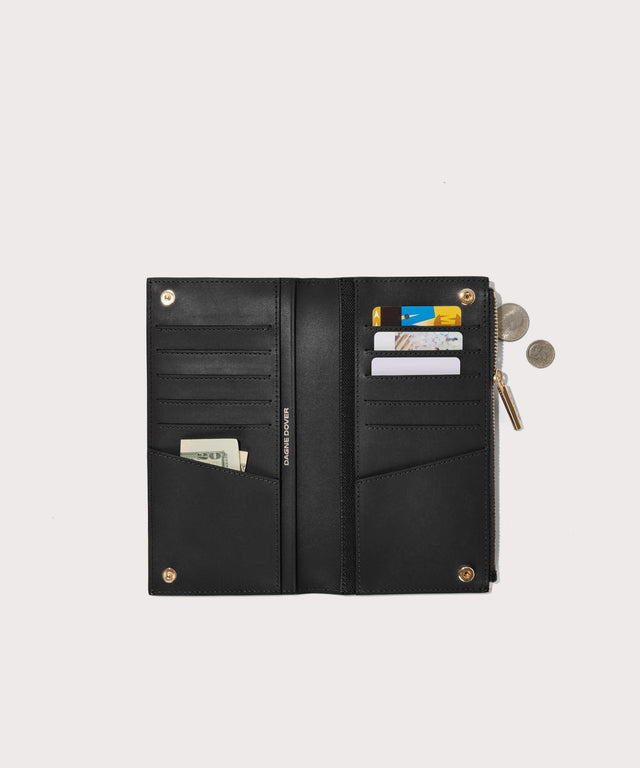 Dagne Dover Slim Wallet in black unclasped, revealing ten card slots, two additional slip pockets, and four cash pockets.