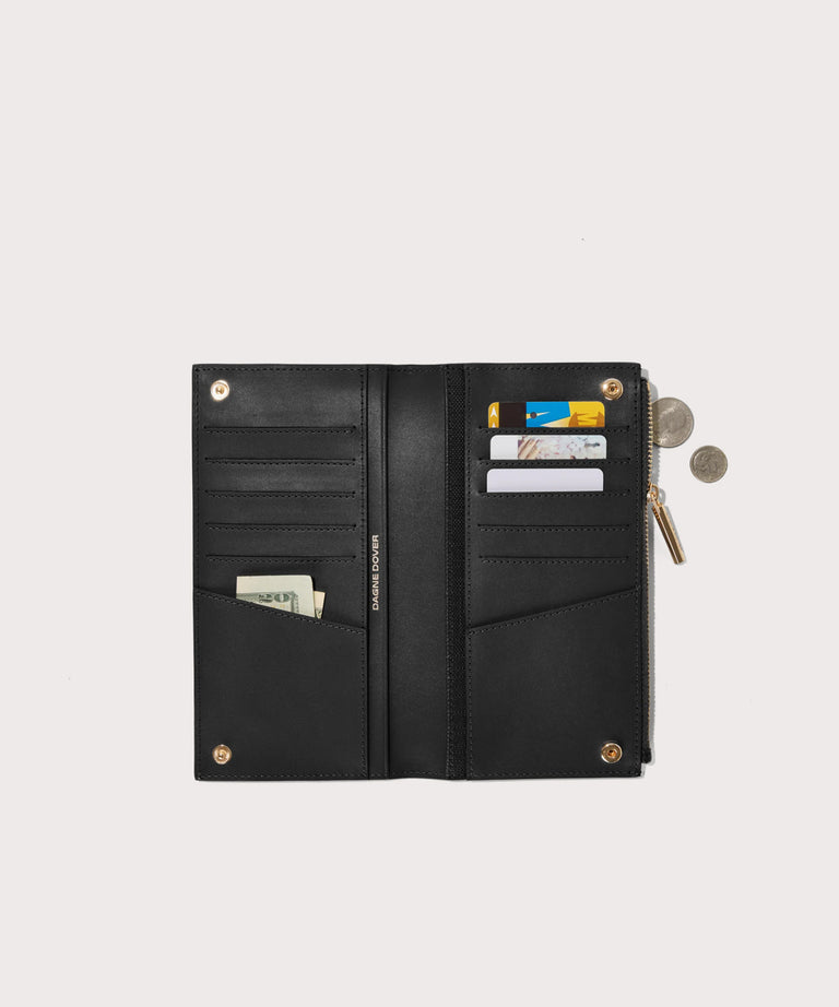 Dagne Dover Slim Wallet in black unclasped, revealing ten card slots, two additional slip pockets, and four cash pockets.